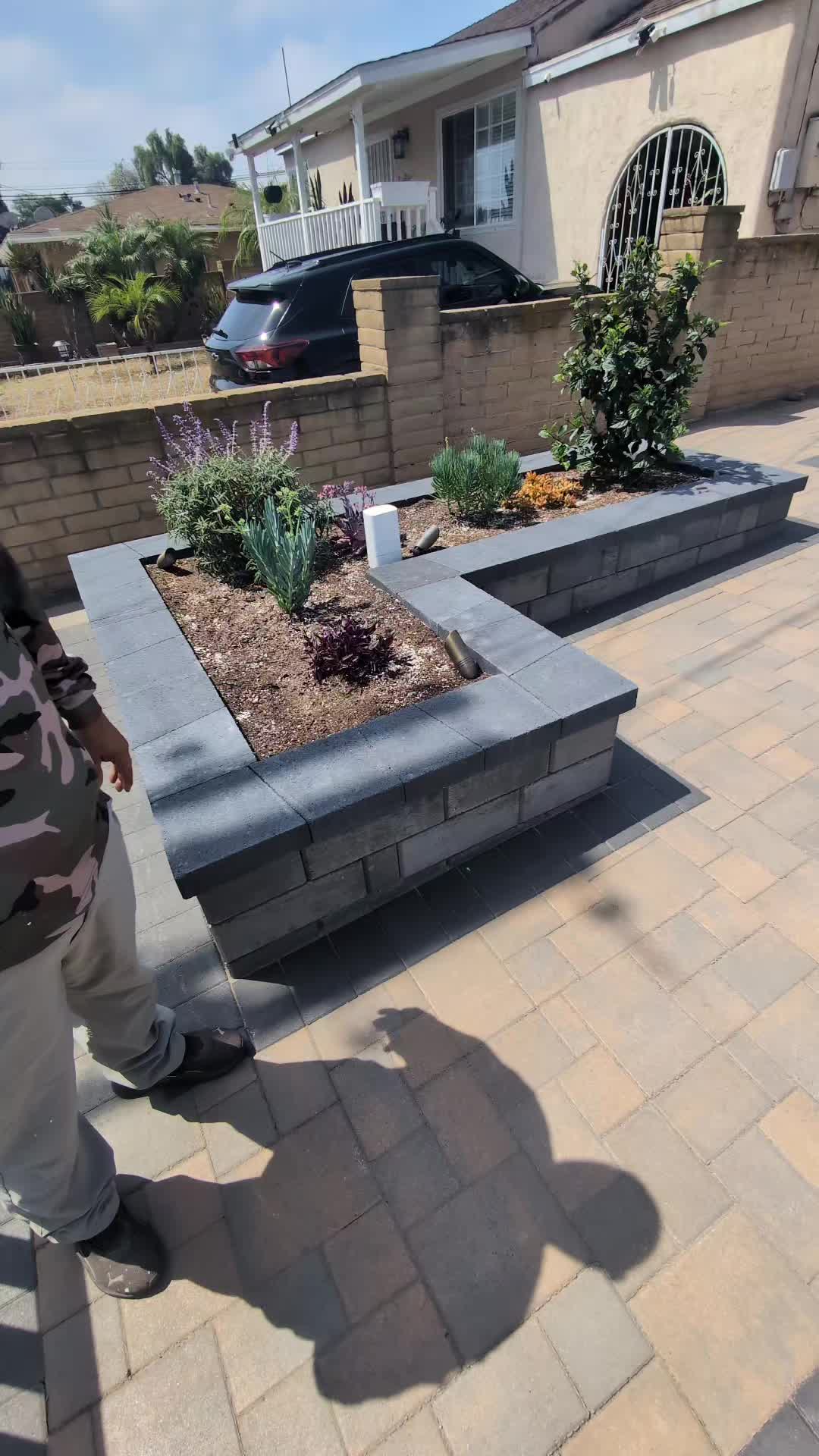 L-Shaped Charcoal Segmental Block Raised Planter Walls on Paver Courtyards in San Diego (2026 Guide)